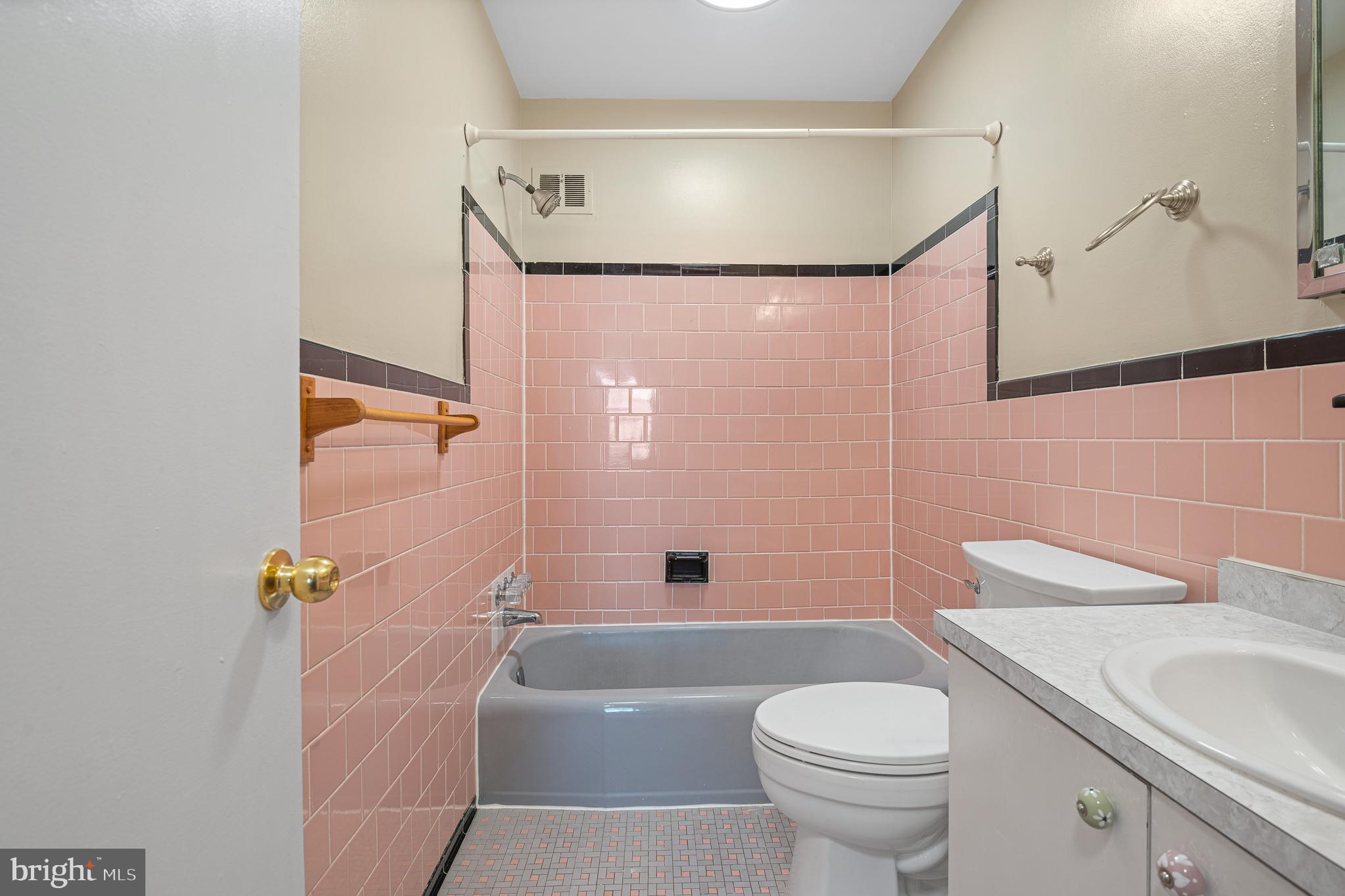 9713 Byeforde Road Kensington, MD 20895 - Photo 23 of 56 a bathroom with a sink a toilet and shower