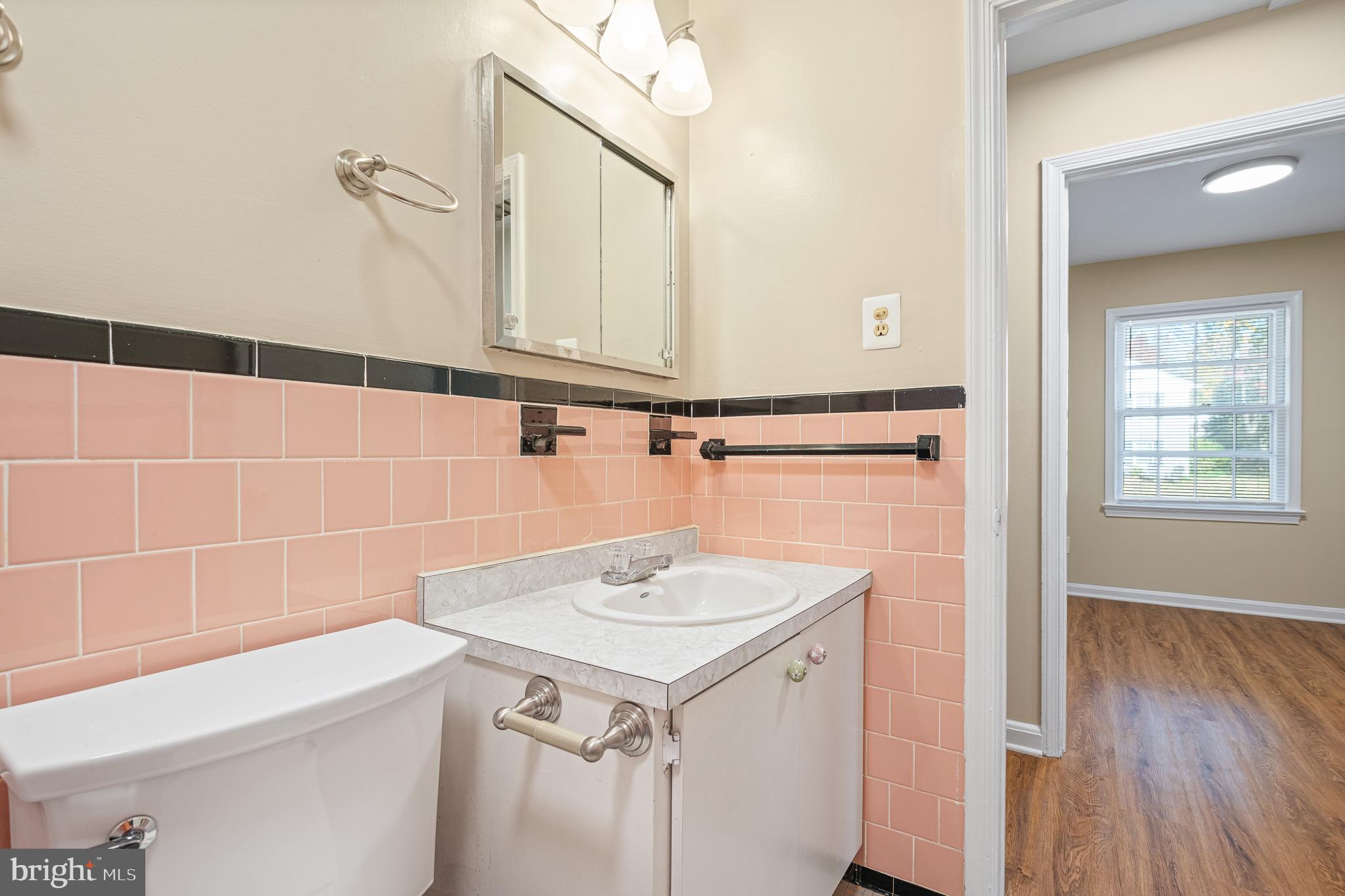 9713 Byeforde Road Kensington, MD 20895 - Photo 25 of 56 a bathroom with a sink and a mirror