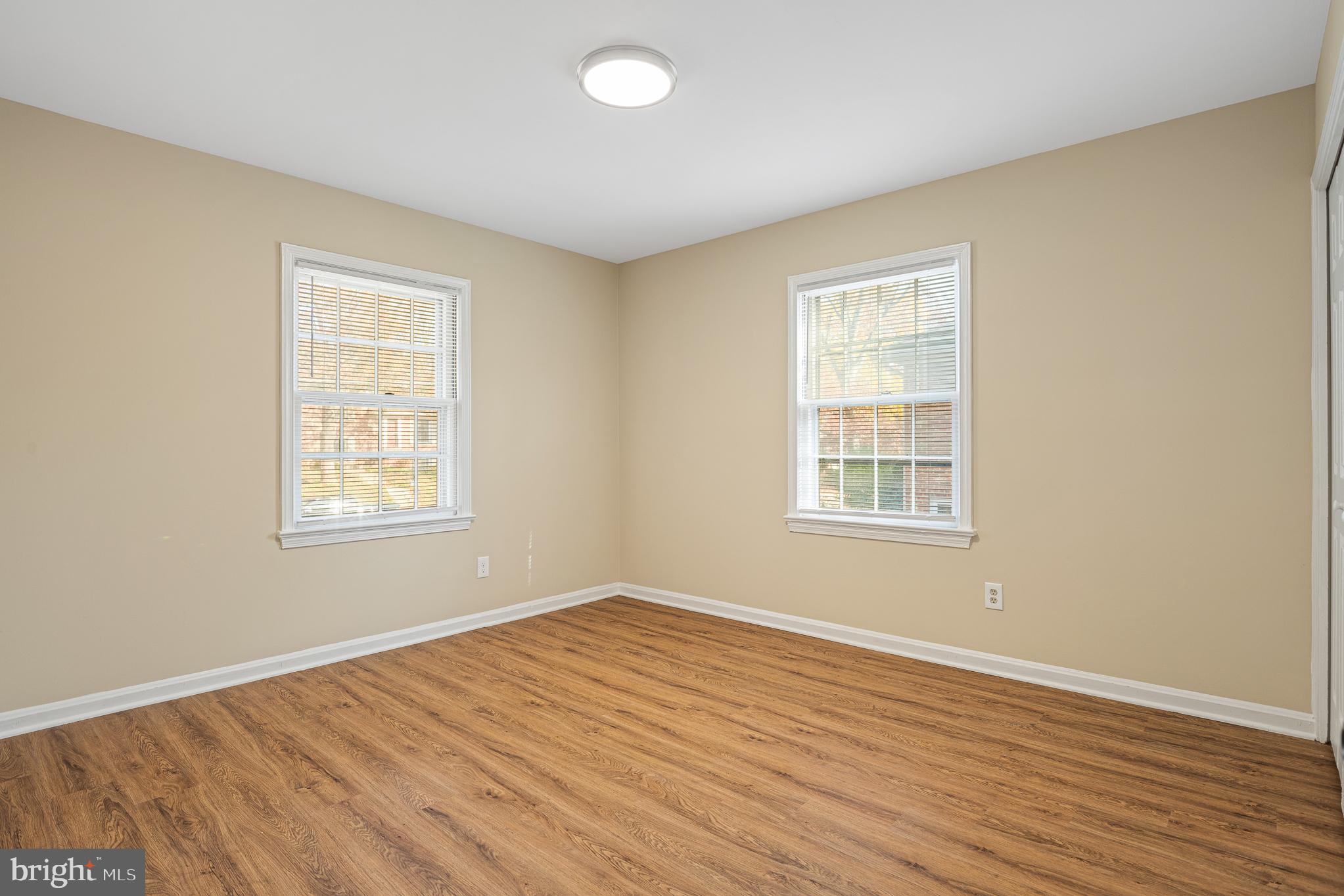 9713 Byeforde Road Kensington, MD 20895 - Photo 26 of 56 a view of an empty room with wooden floor and a window