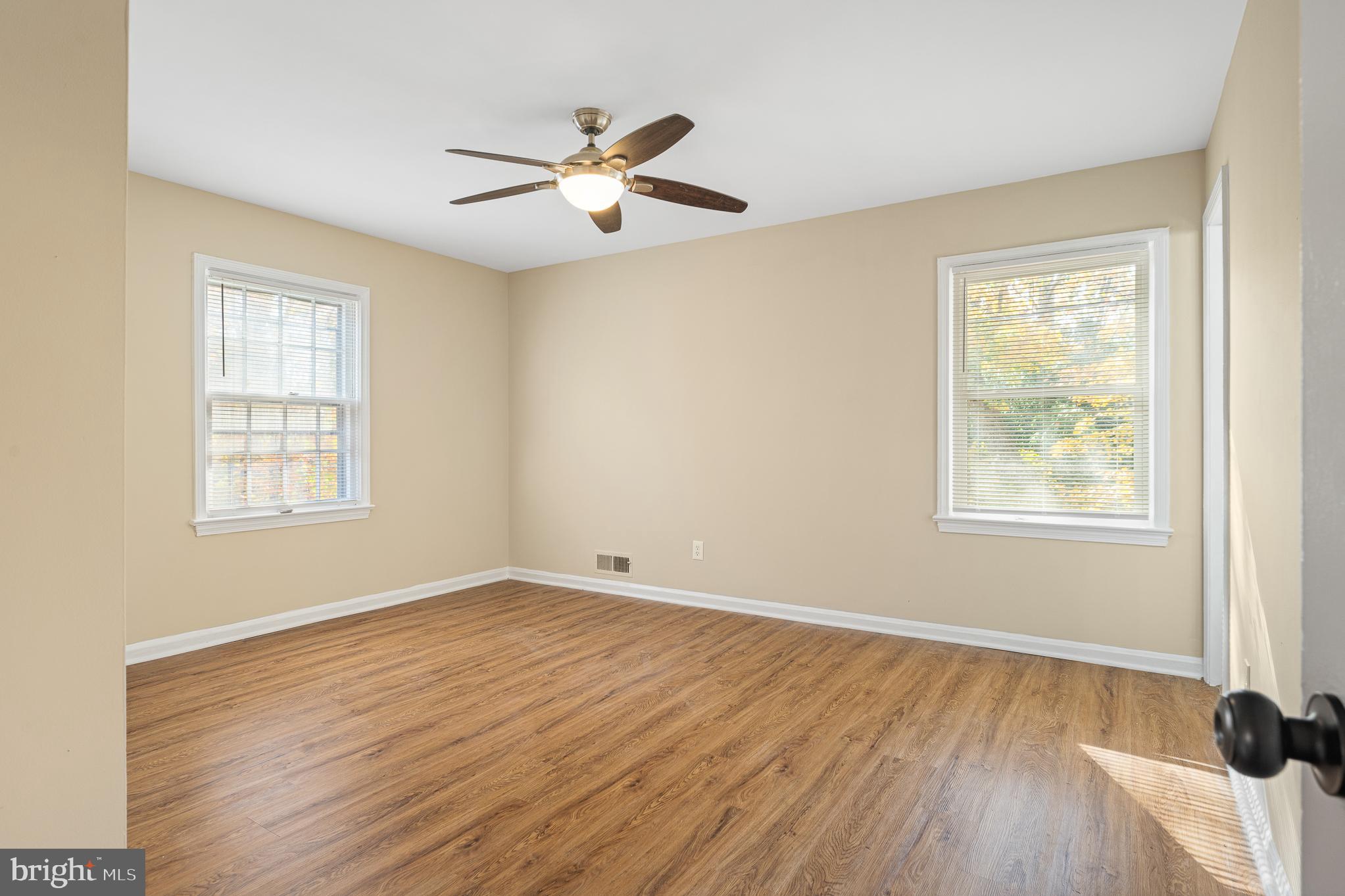 9713 Byeforde Road Kensington, MD 20895 - Photo 29 of 56 a view of an empty room with wooden floor and a window