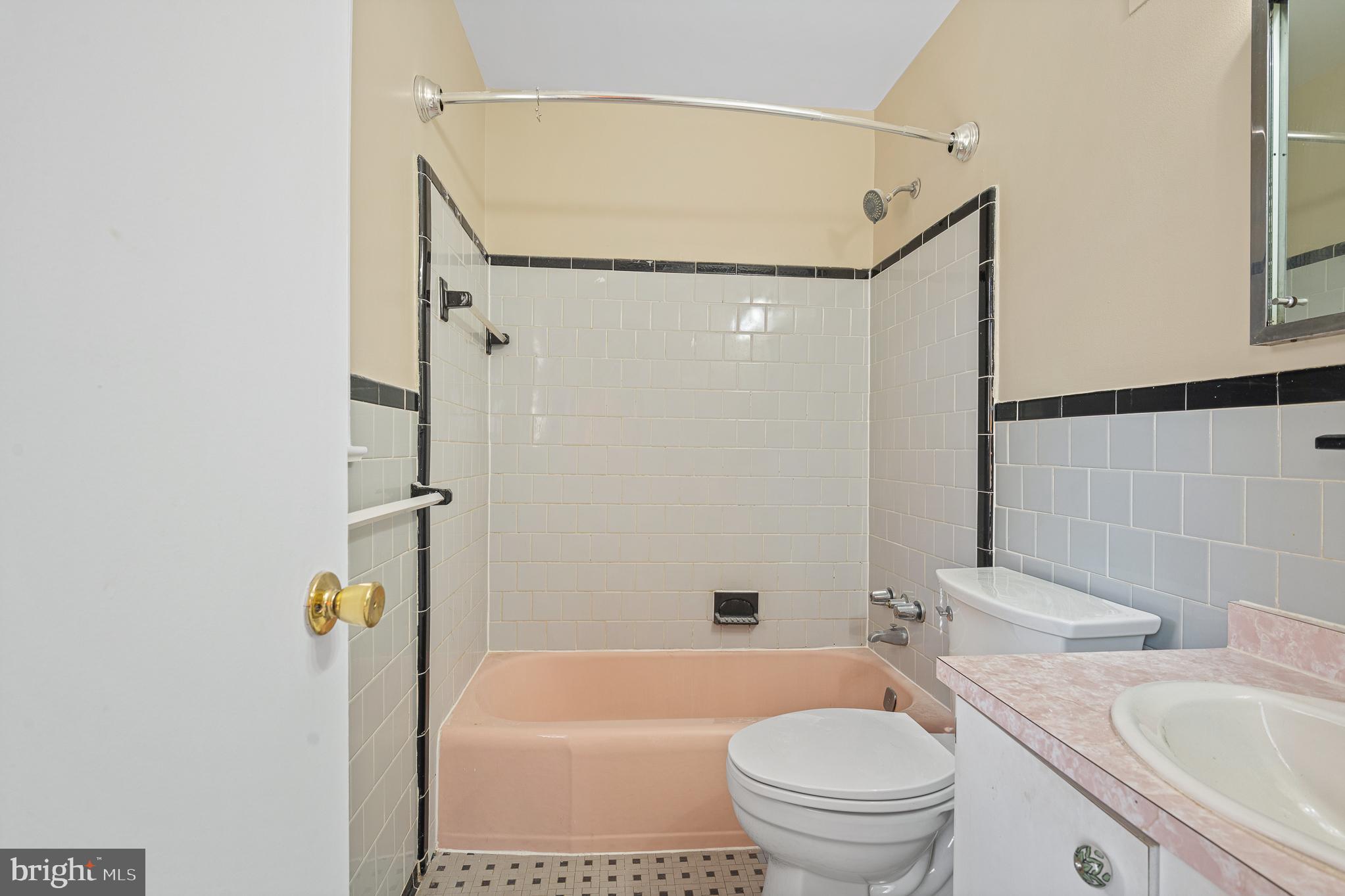 9713 Byeforde Road Kensington, MD 20895 - Photo 33 of 56 a bathroom with a sink a toilet and shower