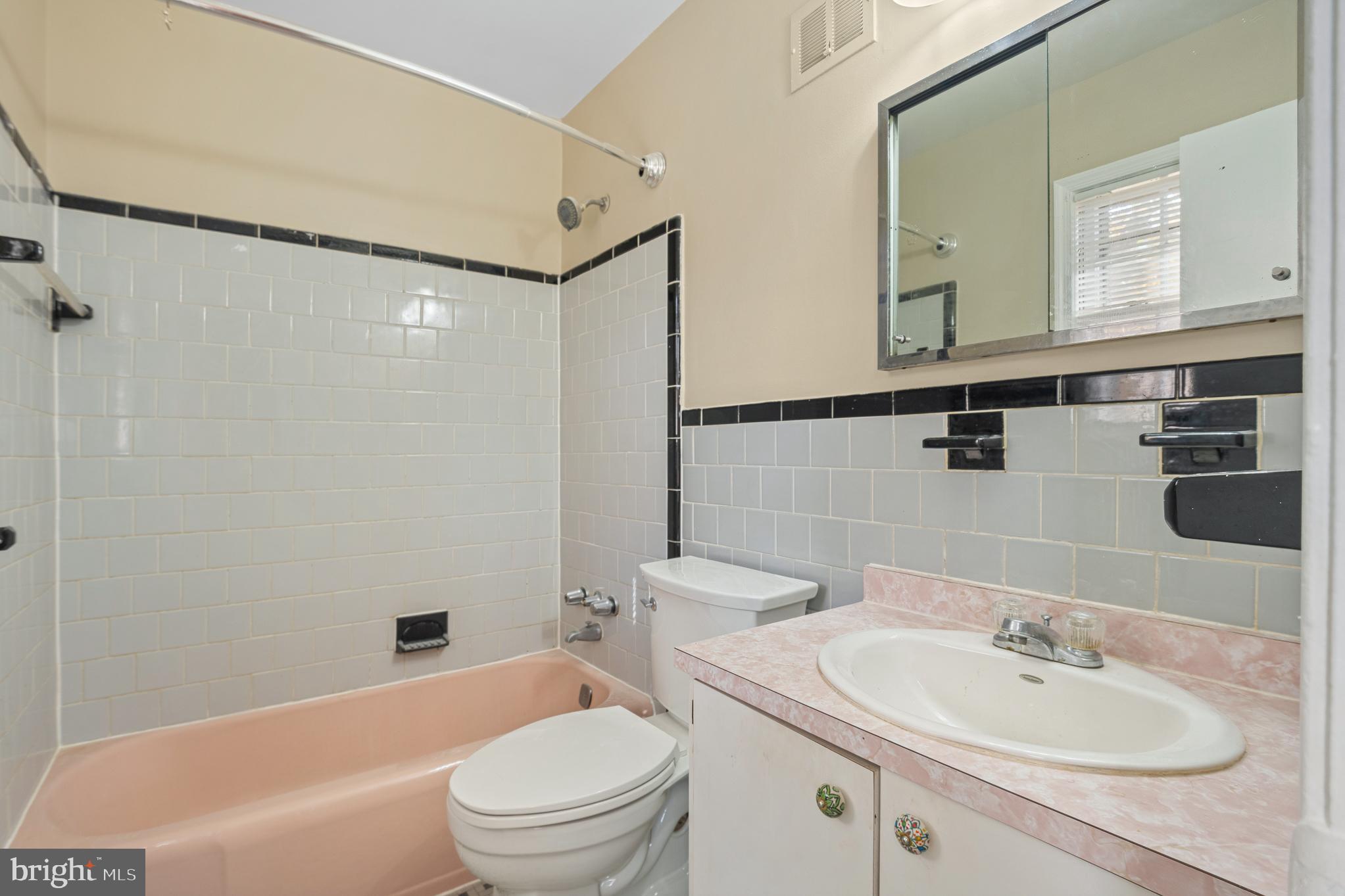9713 Byeforde Road Kensington, MD 20895 - Photo 34 of 56 a bathroom with a sink a toilet and shower