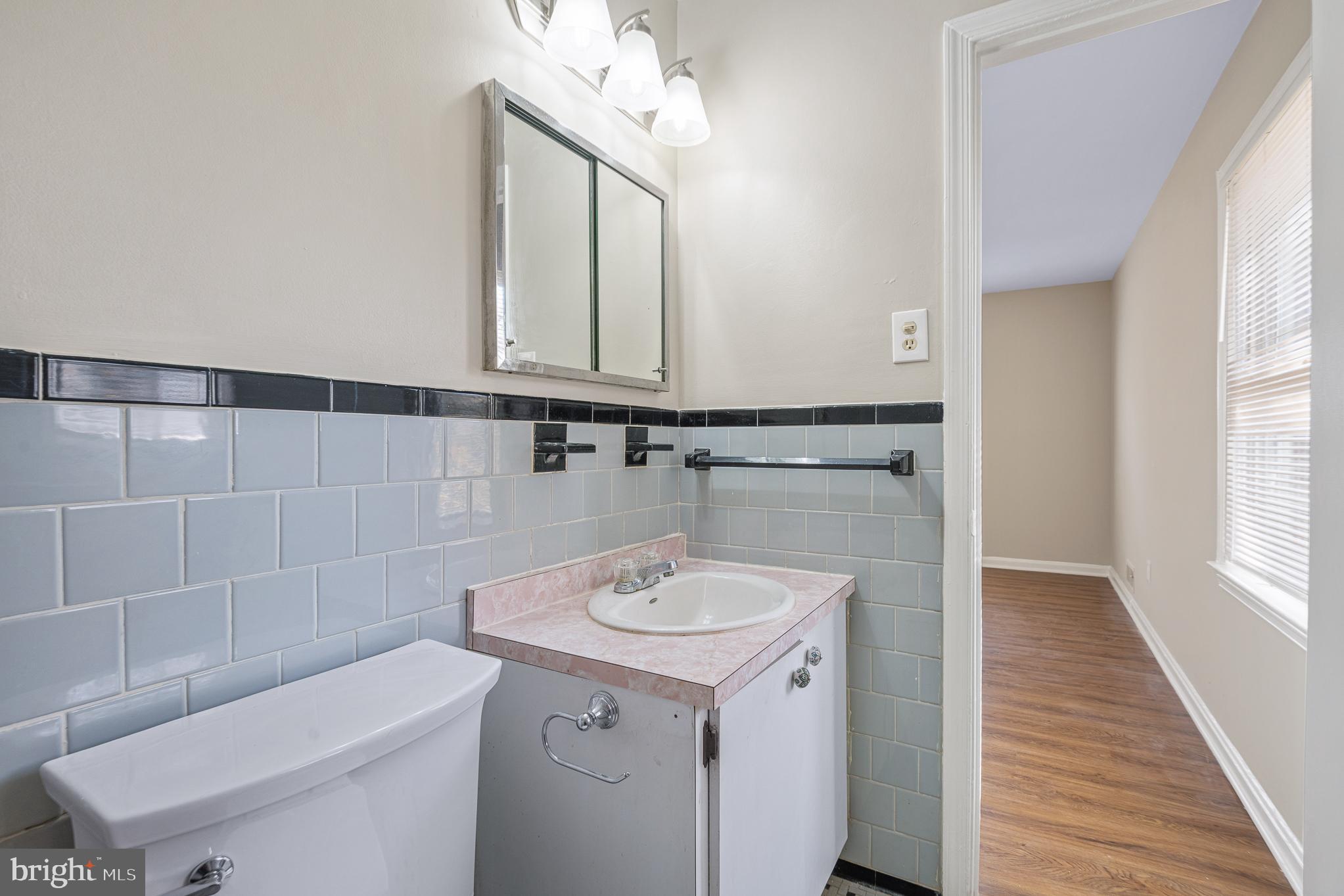9713 Byeforde Road Kensington, MD 20895 - Photo 35 of 56 a bathroom with a sink a toilet and a mirror