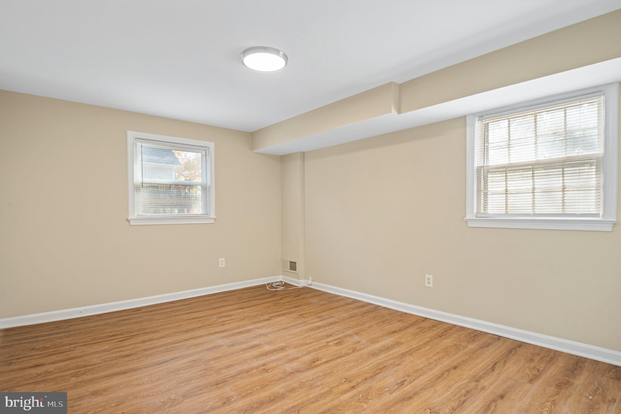 9713 Byeforde Road Kensington, MD 20895 - Photo 40 of 56 an empty room with wooden floor and windows