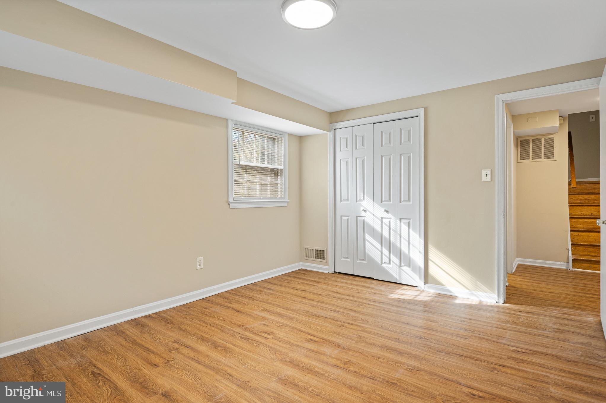 9713 Byeforde Road Kensington, MD 20895 - Photo 41 of 56 a view of an empty room with wooden floor and a window