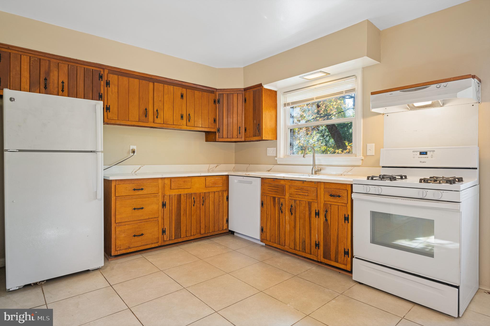 9713 Byeforde Road Kensington, MD 20895 - Photo 8 of 56 a kitchen with cabinets appliances a sink and a window