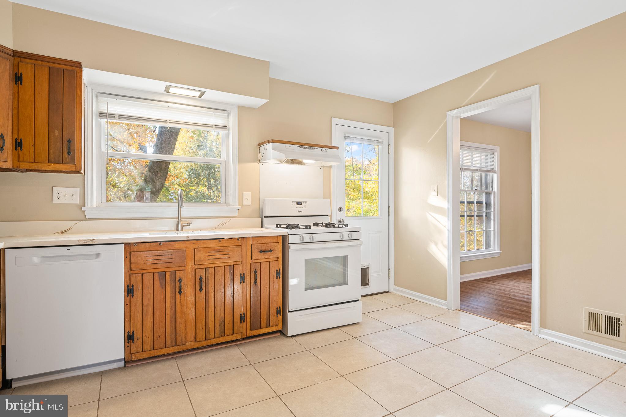 9713 Byeforde Road Kensington, MD 20895 - Photo 9 of 56 a kitchen with stainless steel appliances granite countertop a stove a sink and a refrigerator