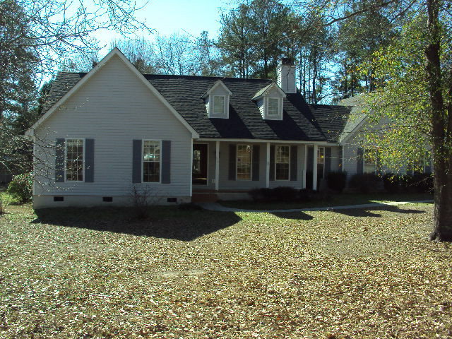 a view of house with yard and green space