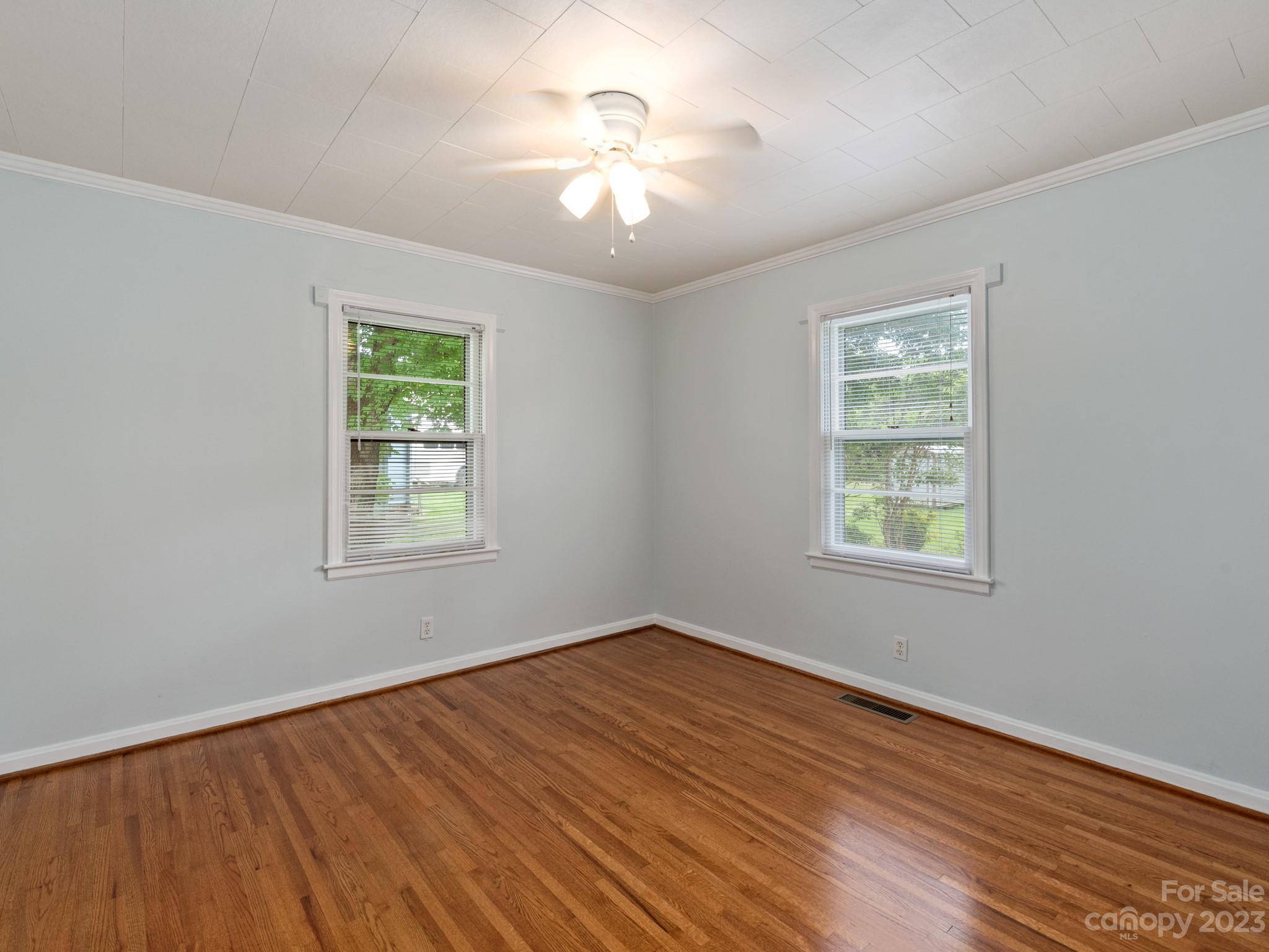 342 Union Cemetery Road Southwest Concord, NC 28027 - Photo 15 of 30 wooden floor in an empty room with a window