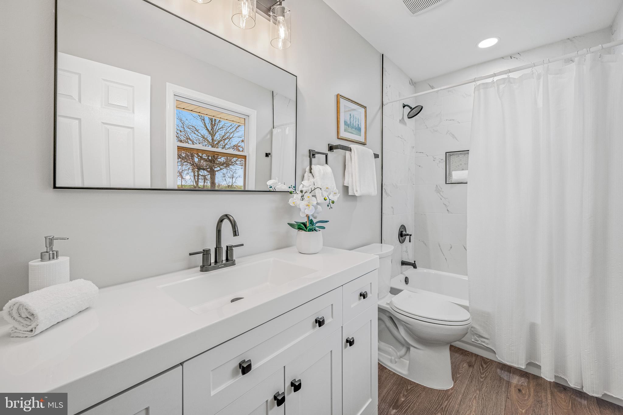 17731 Mason Dixon Road Hagerstown, MD 21740 - Photo 18 of 51 a bathroom with a granite countertop sink mirror vanity and toilet