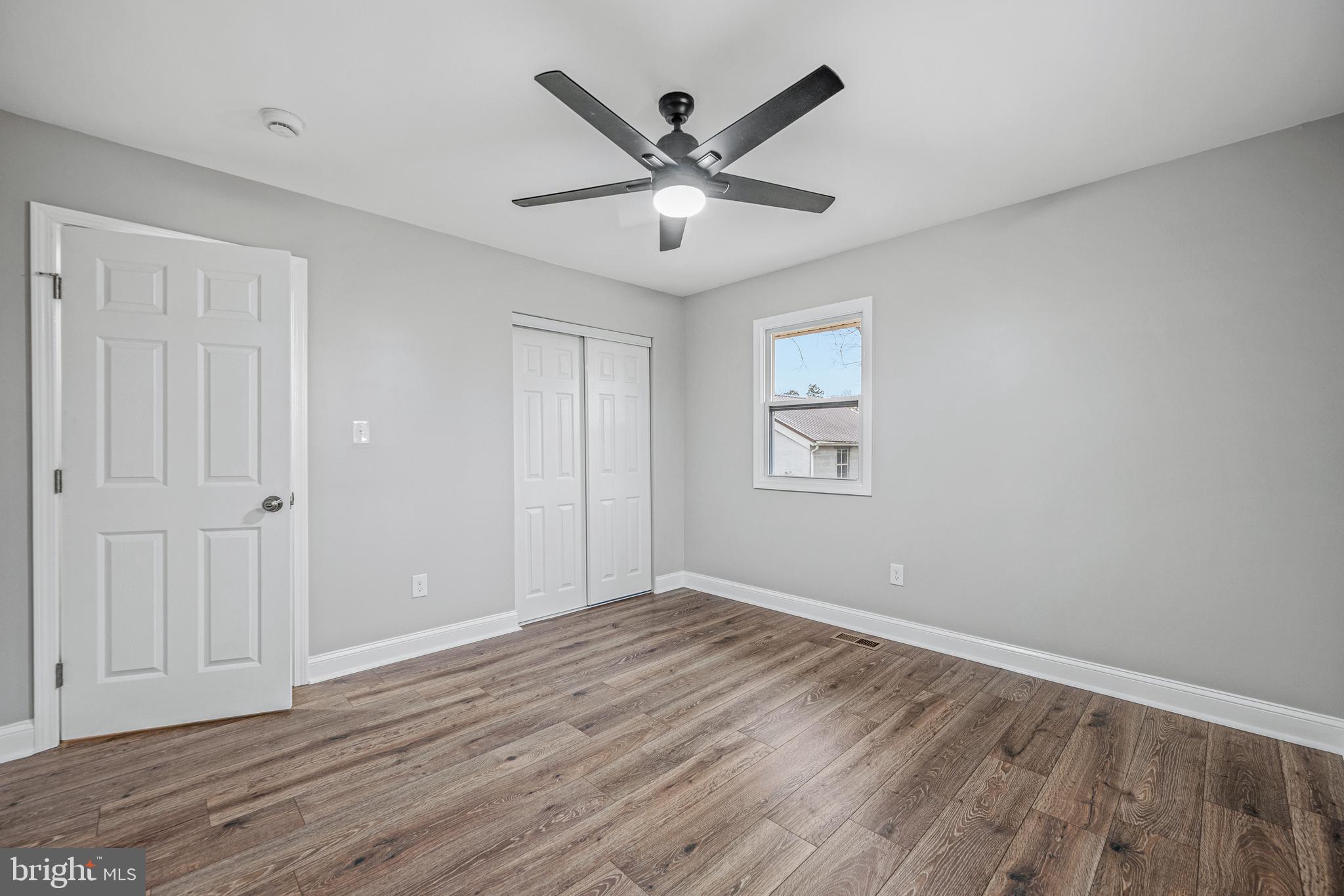 17731 Mason Dixon Road Hagerstown, MD 21740 - Photo 23 of 51 an empty room with wooden floor and ceiling fan