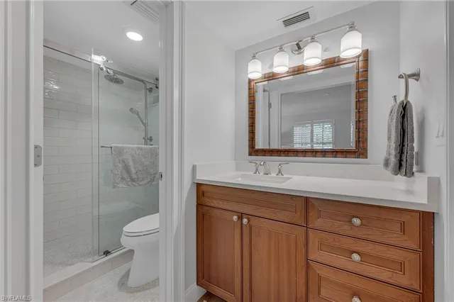 a bathroom with a toilet a sink and shower