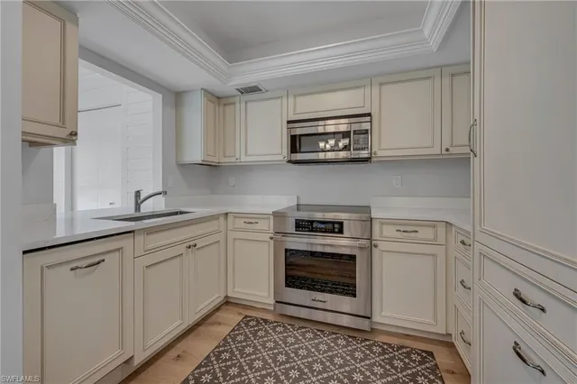 a kitchen with stainless steel appliances granite countertop a sink and a stove