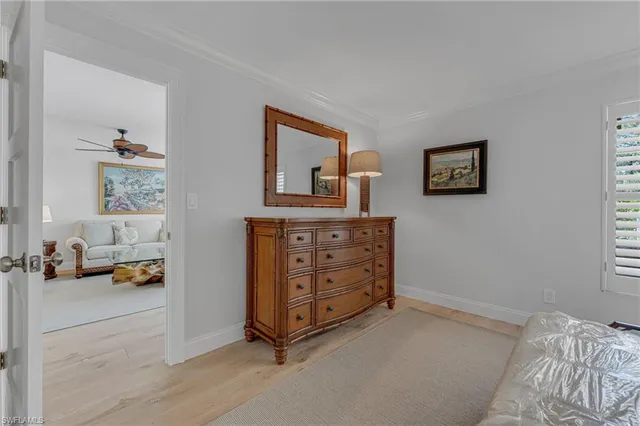a view of a bedroom with baby crib and lounge chair