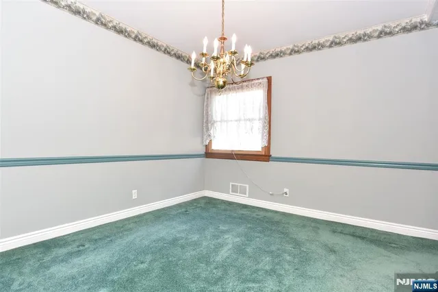 a view of a room with window and chandelier