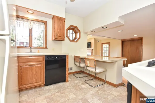 a living room with granite countertop furniture a large window and a clock