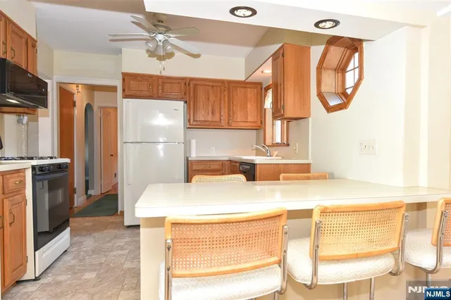 a kitchen with a sink a refrigerator and a stove