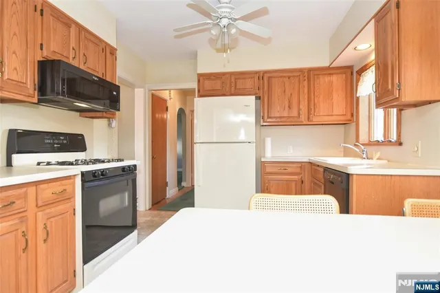 a kitchen with a refrigerator stove and sink