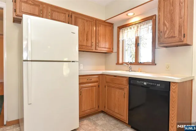 a white refrigerator freezer sitting inside of a kitchen