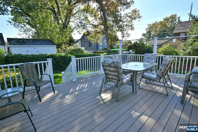 a view of balcony with wooden floor outdoor seating and yard in back