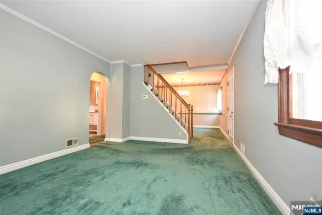 a view of an empty room with stairs