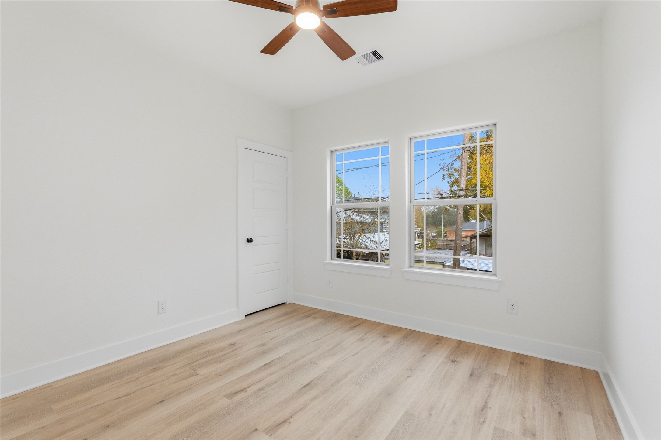 317 South 3rd Street La Porte, TX 77571 - Photo 14 of 15 an empty room with wooden floor and windows