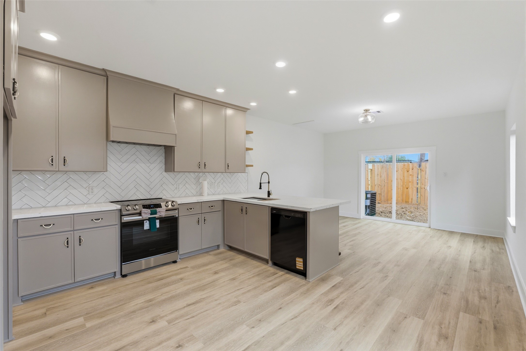 317 South 3rd Street La Porte, TX 77571 - Photo 5 of 15 a large kitchen with granite countertop a stove and a sink