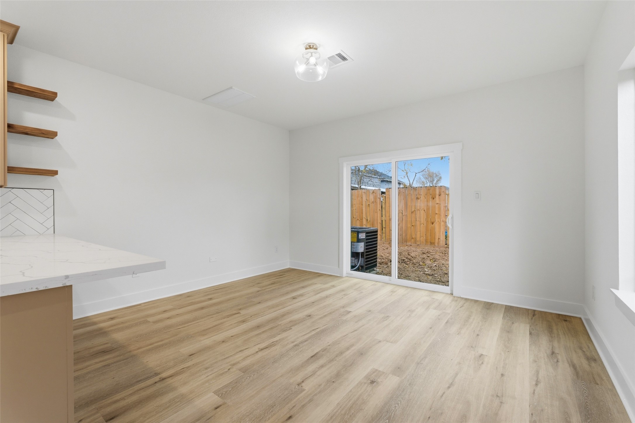 317 South 3rd Street La Porte, TX 77571 - Photo 6 of 15 a view of an empty room with wooden floor and a window