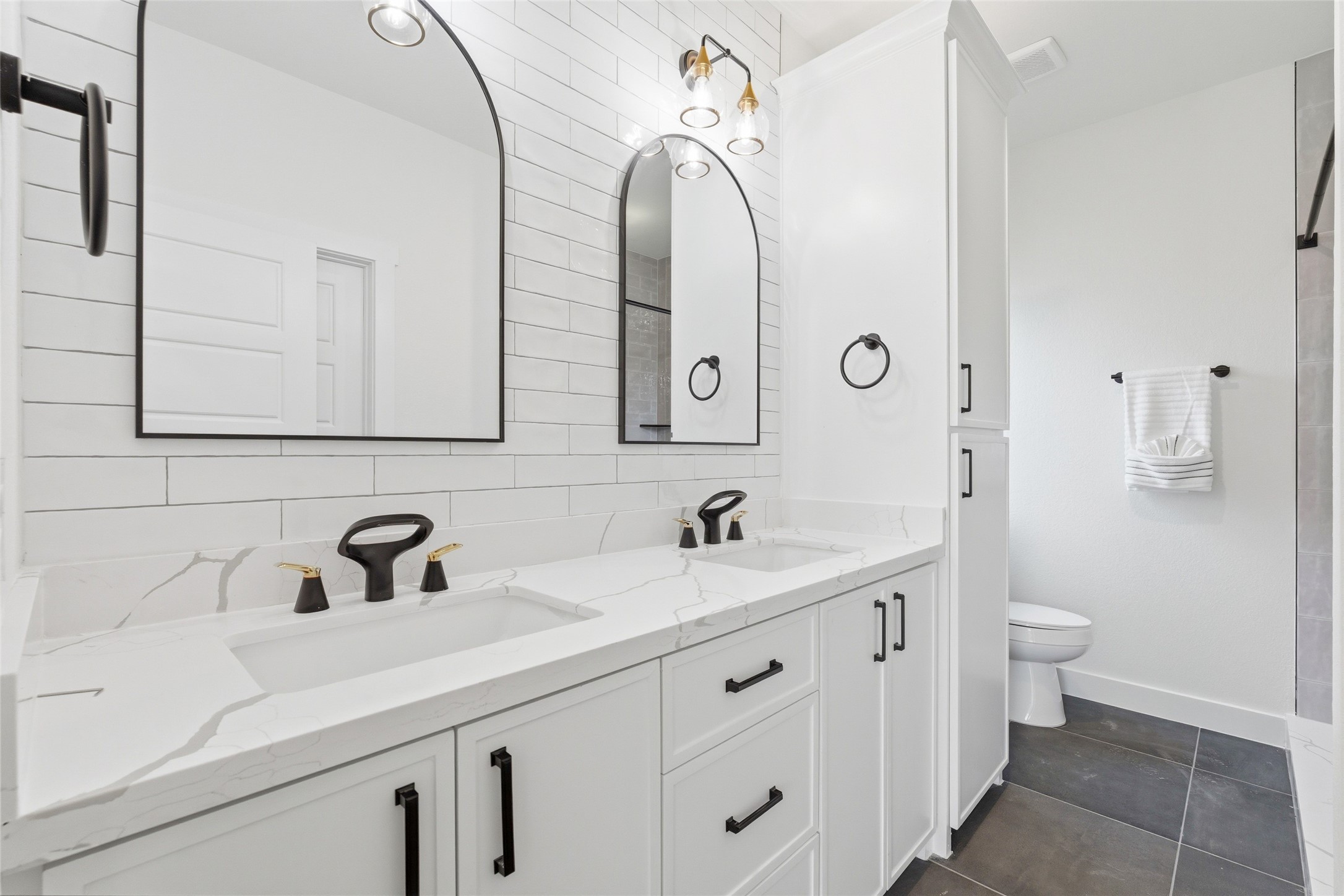317 South 3rd Street La Porte, TX 77571 - Photo 8 of 15 a bathroom with a double vanity sink and a toilet