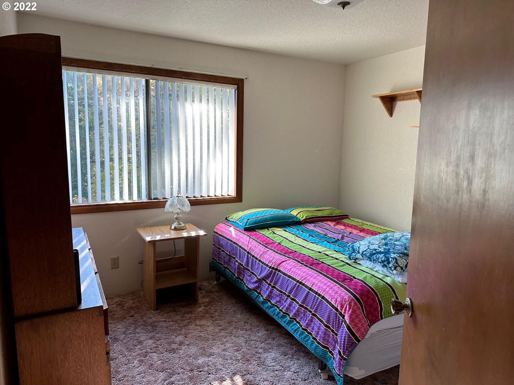 2026 Spring Brook Road Myrtle Creek, OR 97457 - Photo 19 of 32 a bedroom with a bed and a window