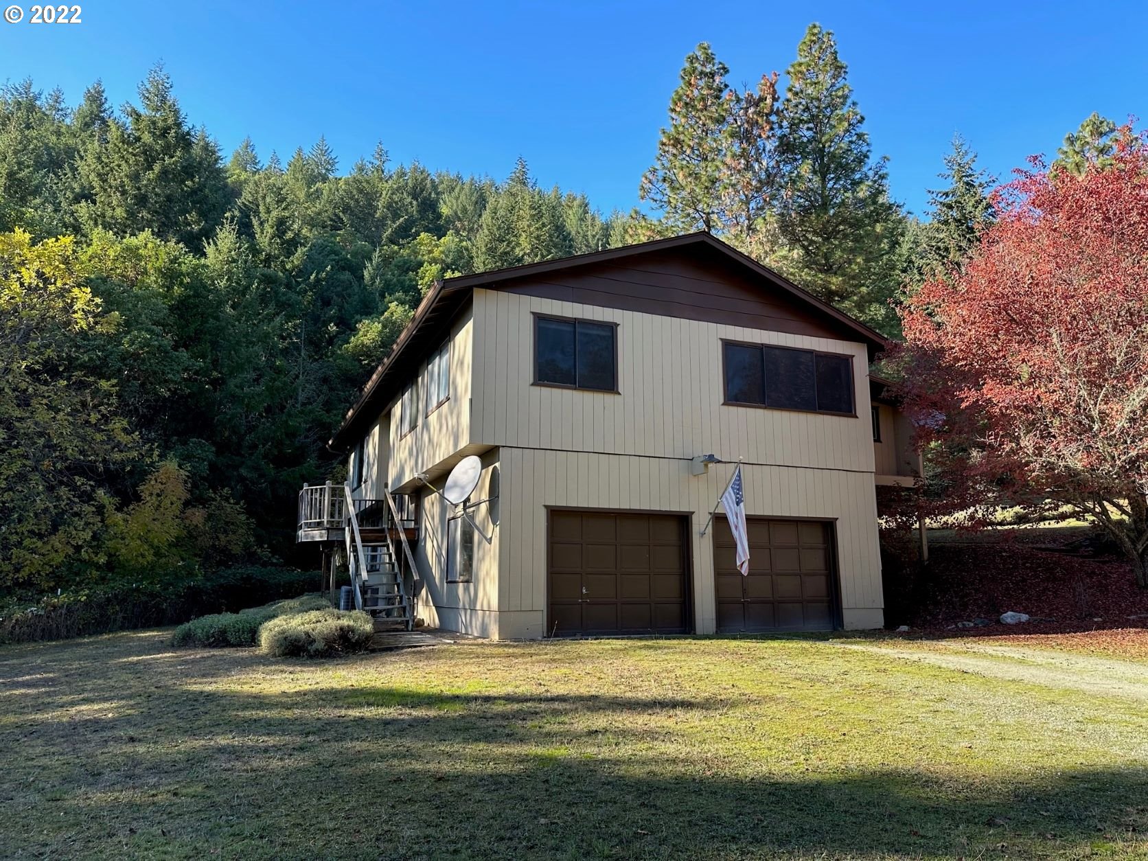2026 Spring Brook Road Myrtle Creek, OR 97457 - Photo 3 of 32 a front view of a house with a yard and garage