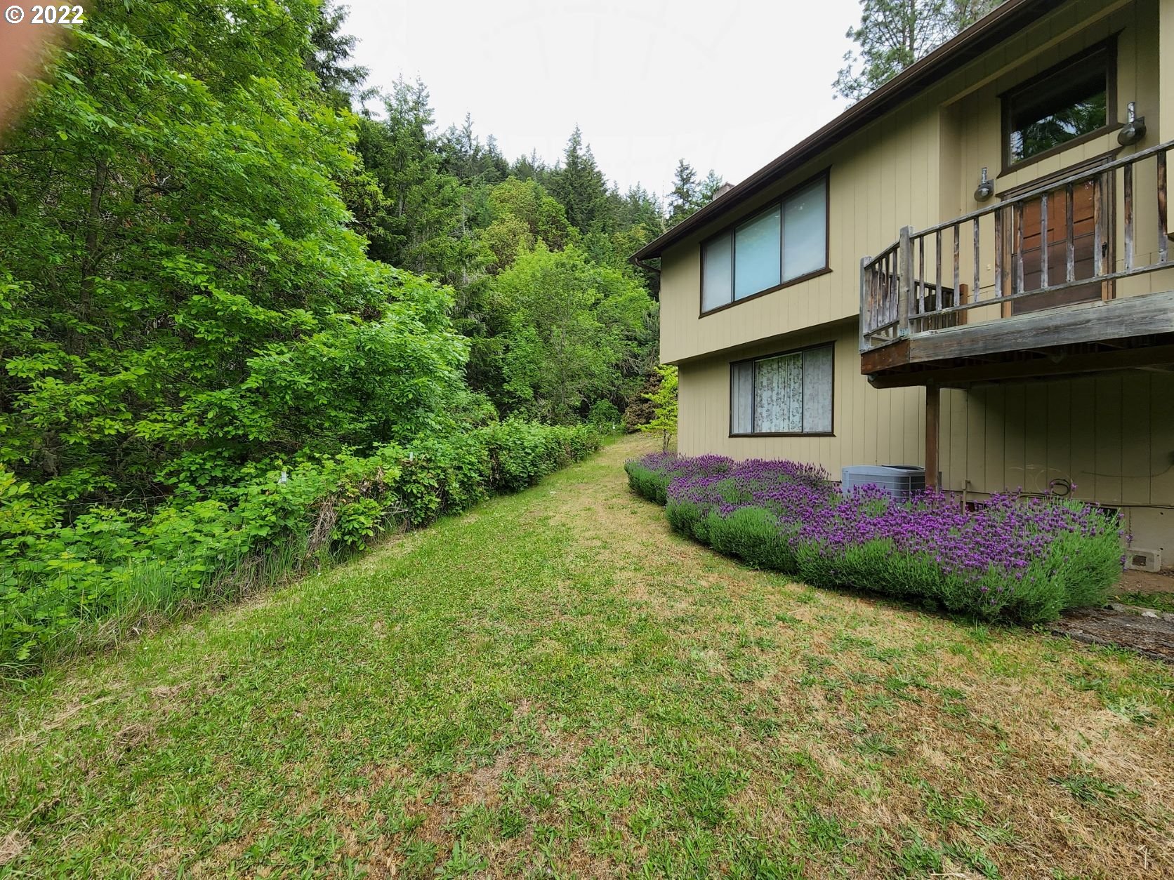 2026 Spring Brook Road Myrtle Creek, OR 97457 - Photo 8 of 32 a view of a house with a yard and a garden