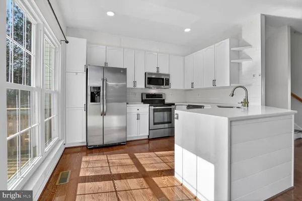 a kitchen with cabinets and stainless steel appliances