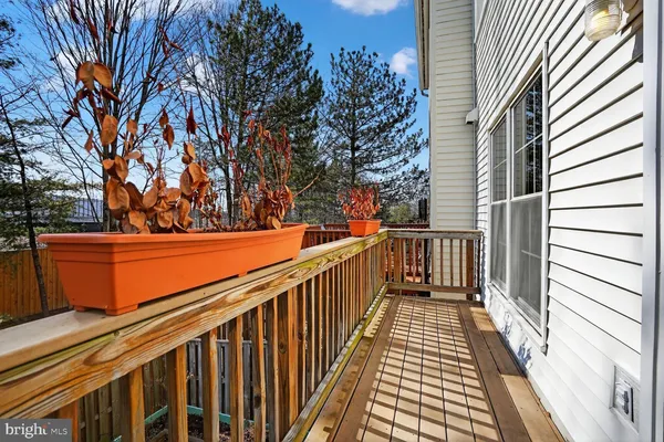 a view of balcony with wooden floor and fence