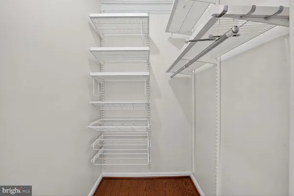 a view of walk in closet with empty racks