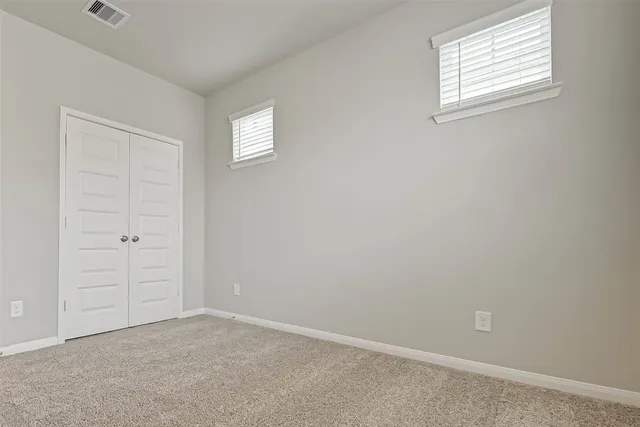 an empty room with closet area
