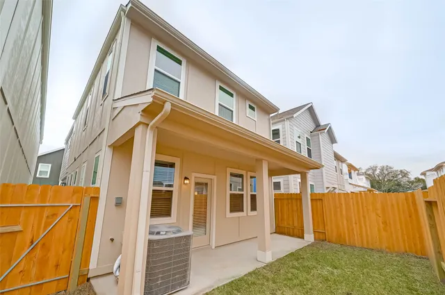 an aerial view of a house with a yard and lake view