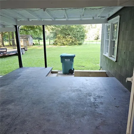 a view of a yard with porch and a back yard