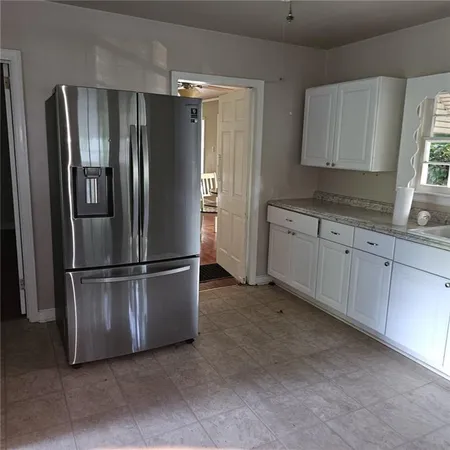 a metallic refrigerator freezer sitting in a kitchen