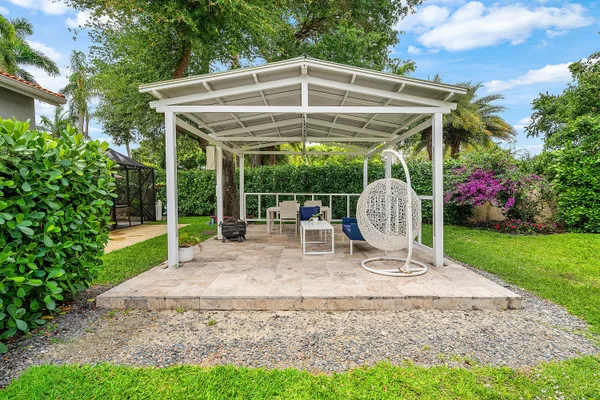 a swimming pool with outdoor seating and yard