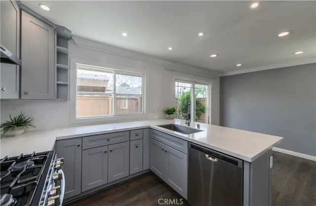 a kitchen with sink and cabinets