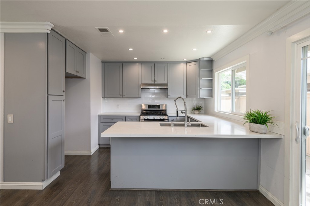2 Hollowglen, Unit 7 Irvine, CA 92604 - Photo 14 of 31 a kitchen with stainless steel appliances a sink stove and refrigerator
