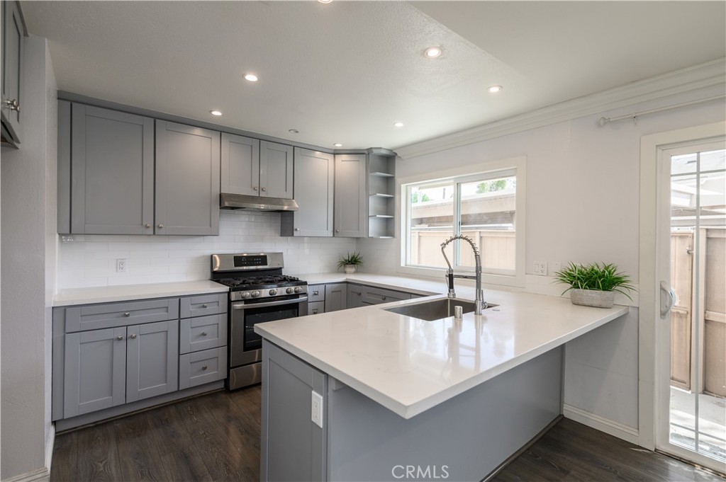 2 Hollowglen, Unit 7 Irvine, CA 92604 - Photo 15 of 31 a kitchen with a sink a stove and cabinets