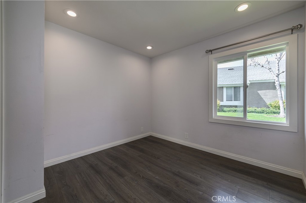2 Hollowglen, Unit 7 Irvine, CA 92604 - Photo 16 of 31 an empty room with wooden floor and windows