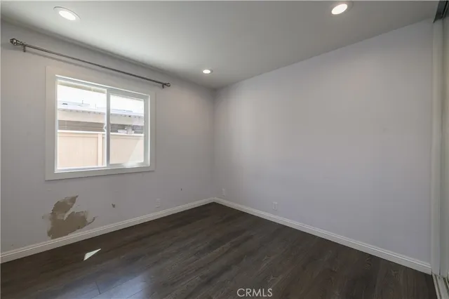 a view of a room with wooden floor and windows