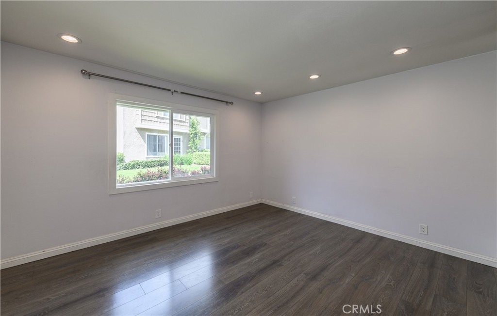 2 Hollowglen, Unit 7 Irvine, CA 92604 - Photo 20 of 31 an empty room with wooden floor and windows