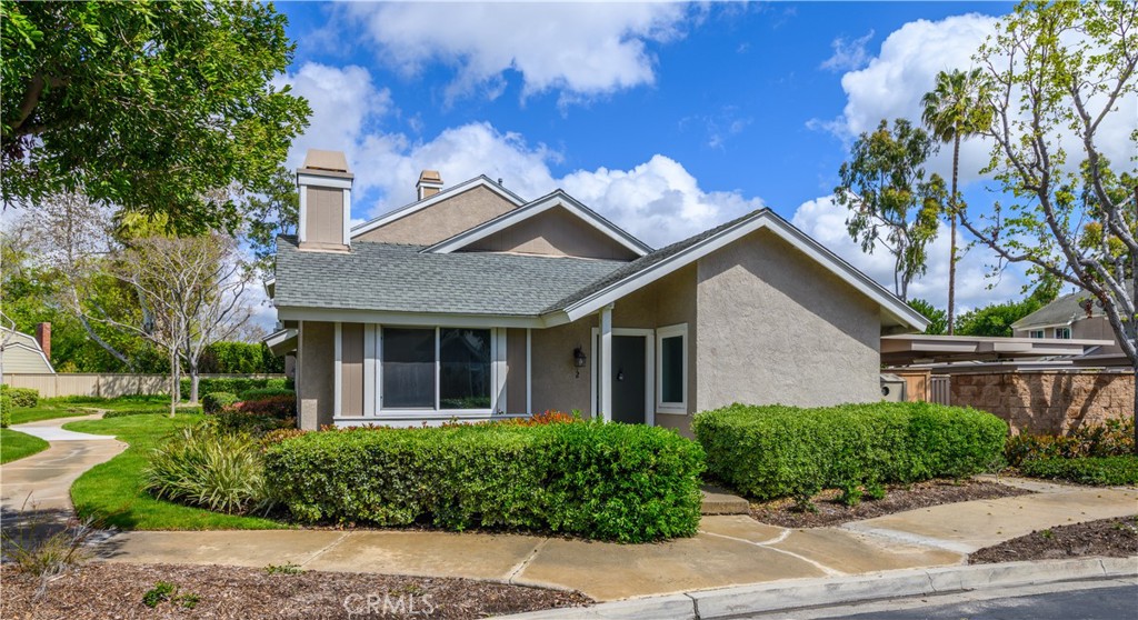 2 Hollowglen, Unit 7 Irvine, CA 92604 - Photo 2 of 31 a front view of a house with a garden