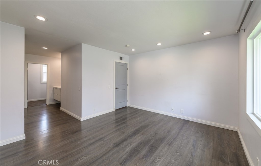 2 Hollowglen, Unit 7 Irvine, CA 92604 - Photo 22 of 31 an empty room with wooden floor and windows