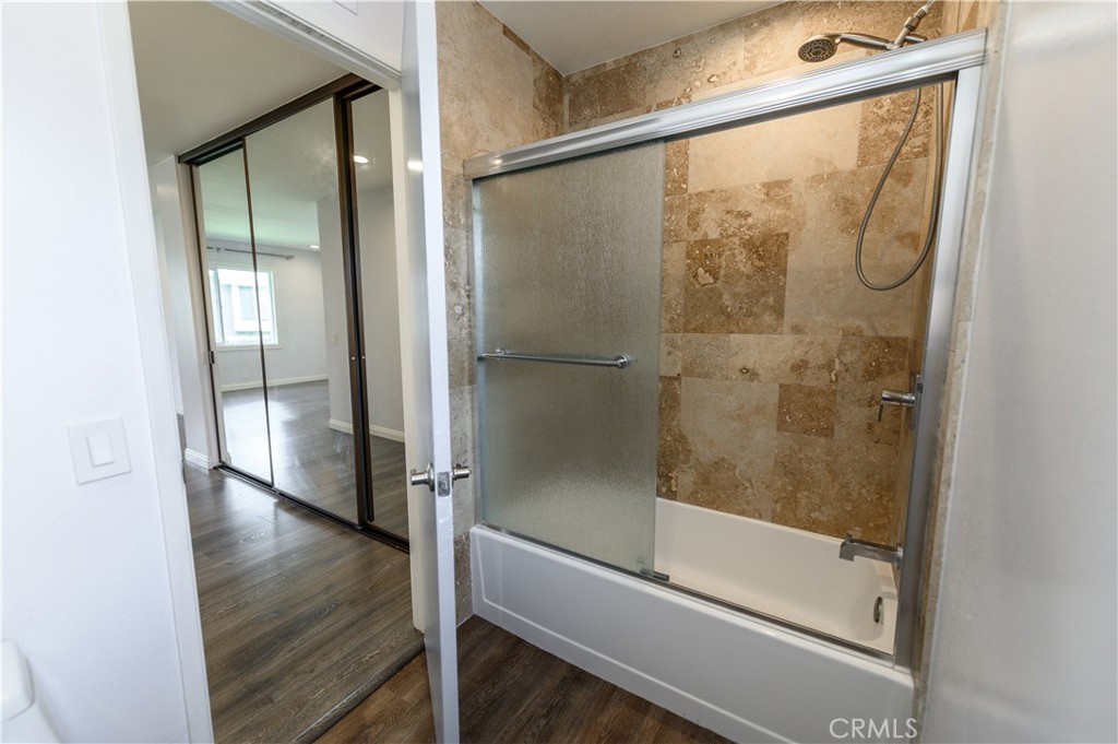 2 Hollowglen, Unit 7 Irvine, CA 92604 - Photo 25 of 31 a bathroom with a glass shower door and a window