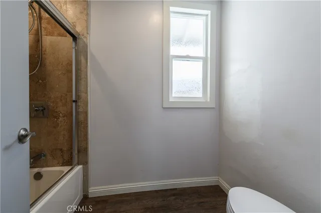 a bathroom with a toilet and shower